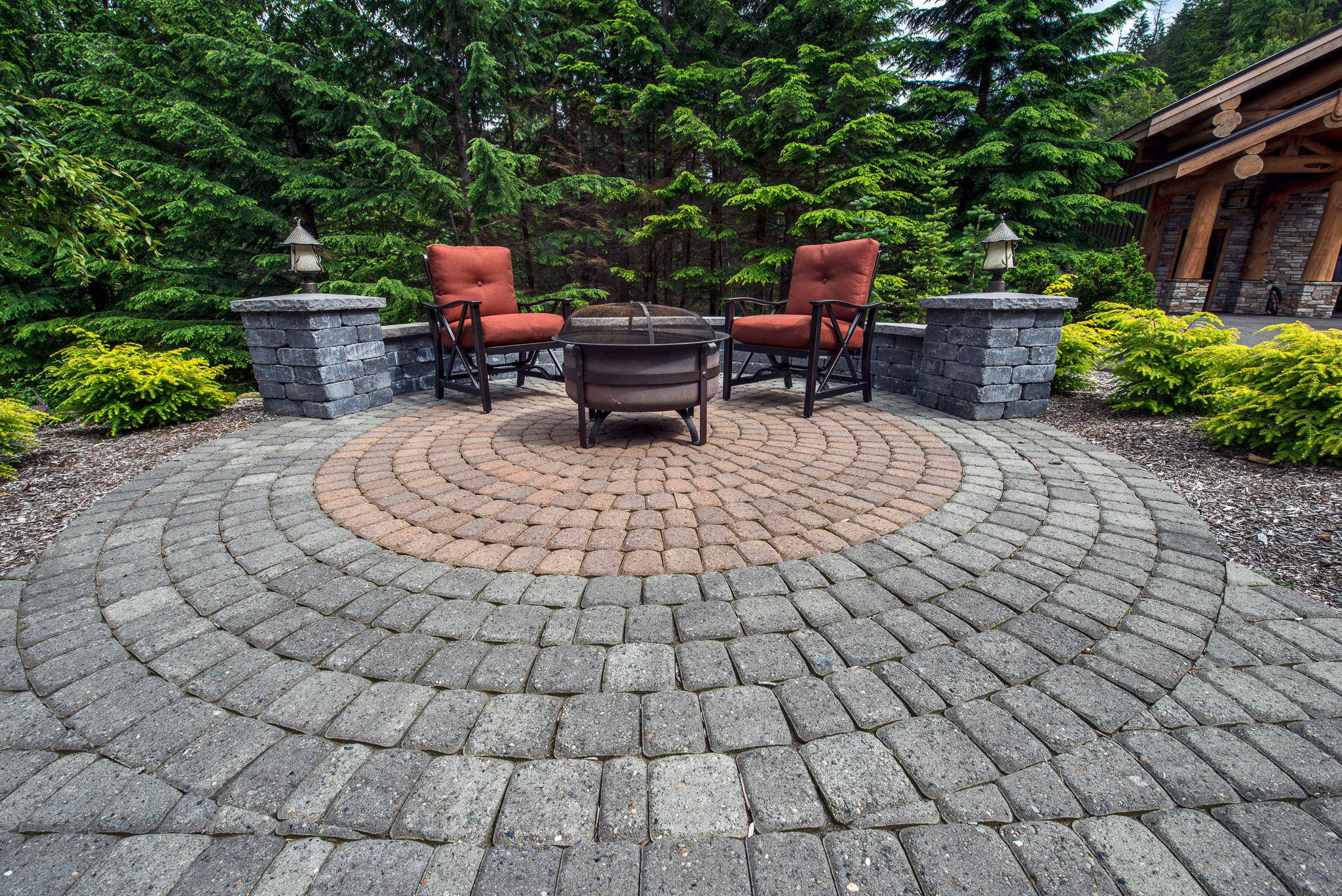 Two-color circular paver patio with seating wall