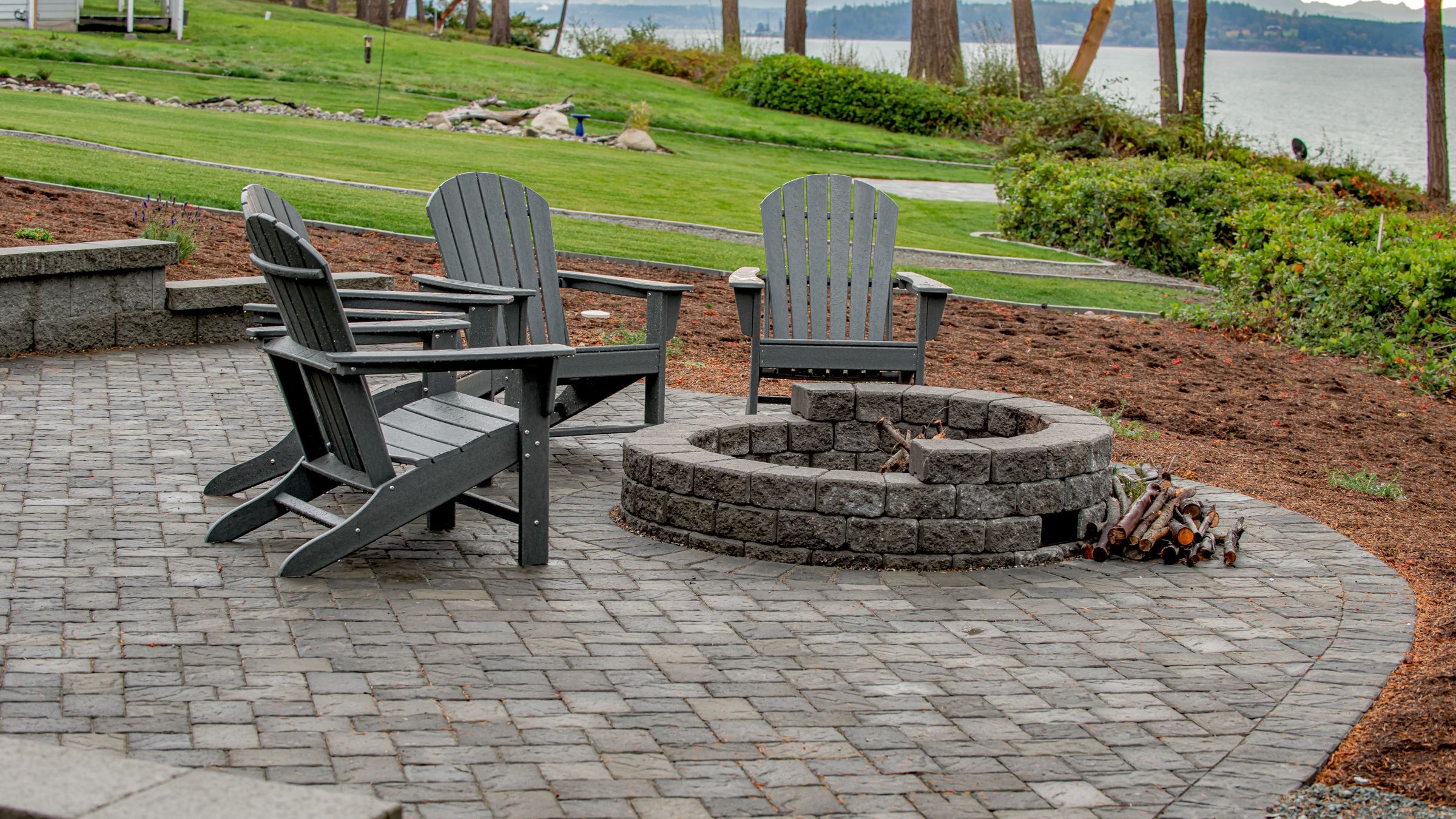 Fire pit serves as a focal point on a small concrete paver patio