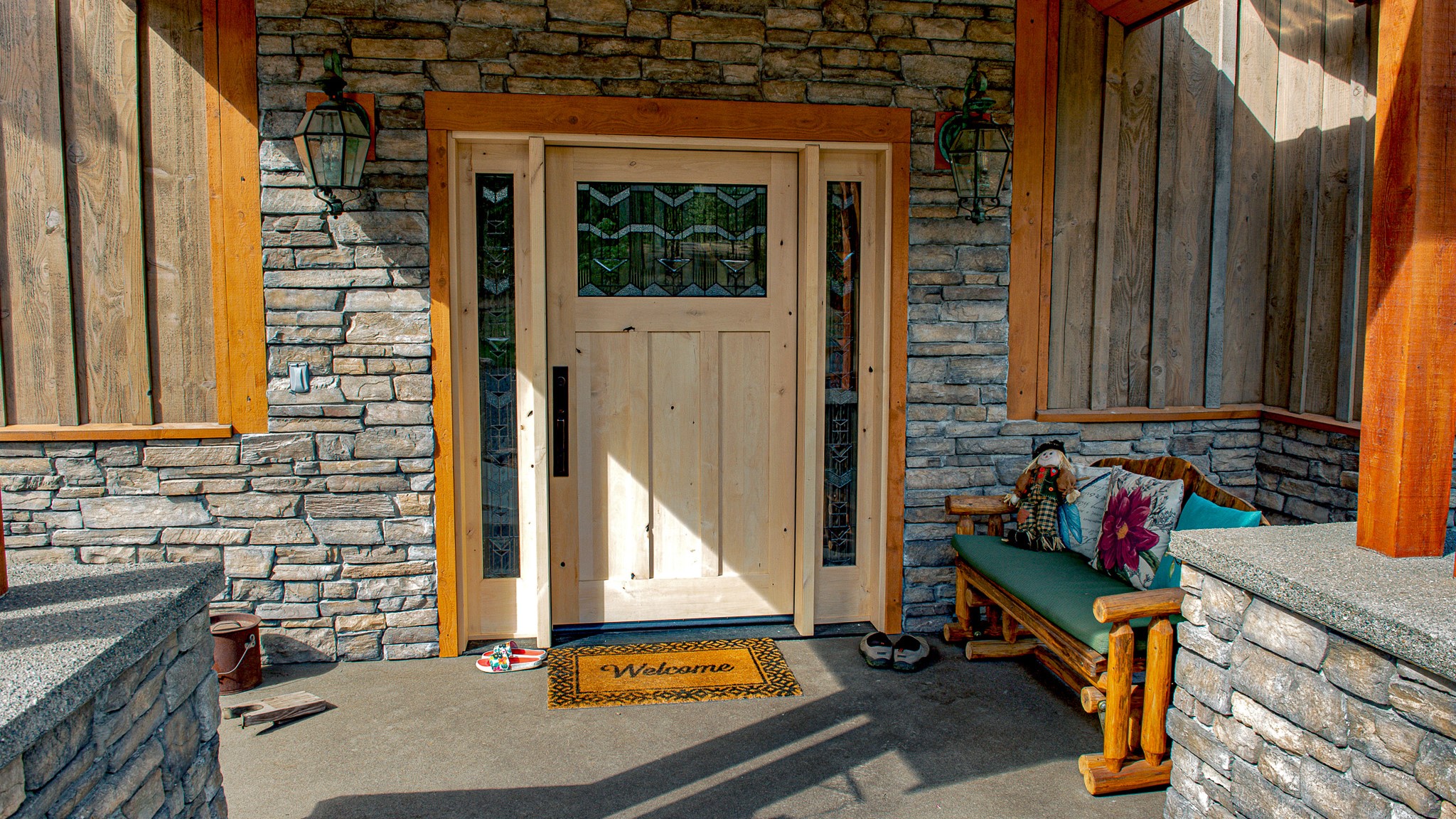 Cultured Stone veneer complements the rich tones of wood on a home