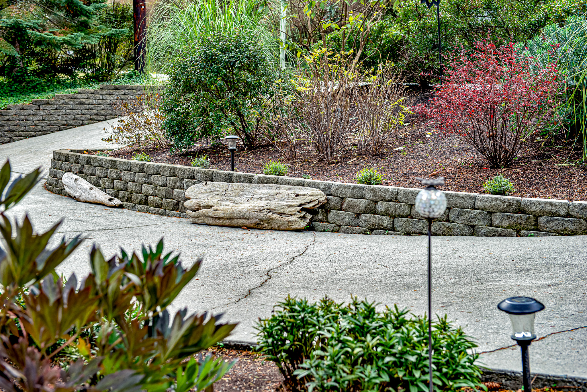 Retaining walls border both sides of a circular driveway